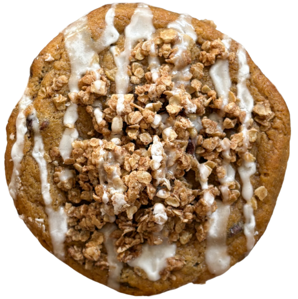 Cookie with oatmeal crumble and white drizzle on a white background