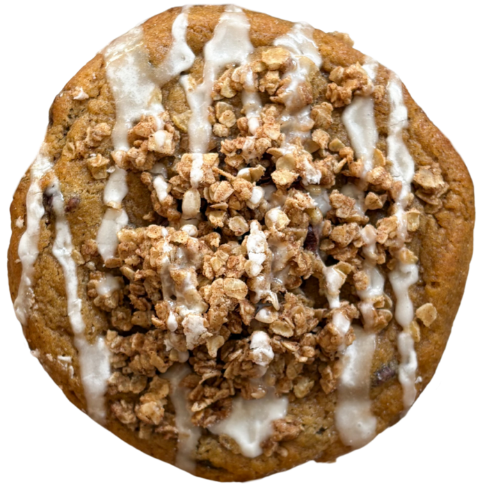 Cookie with oatmeal crumble and white drizzle on a white background